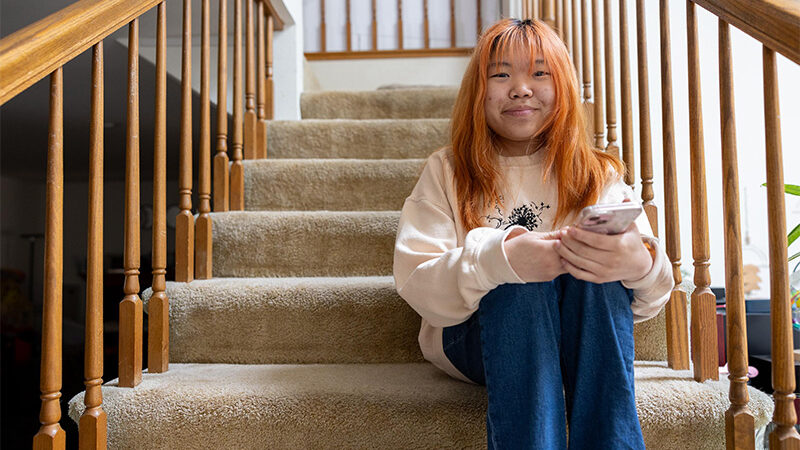 BioMarin patient sitting on her stairs.