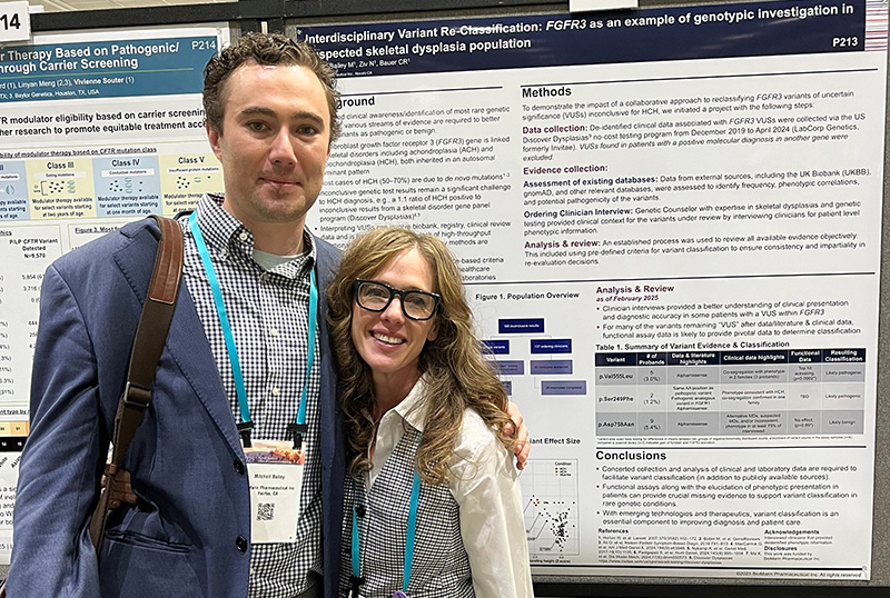 BioMarin Employees Mitch Bailey and Ashley Volz standing in front of a scientific poster