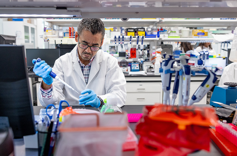 BioMarin employee Sergio Covarrubias pipetting in a lab